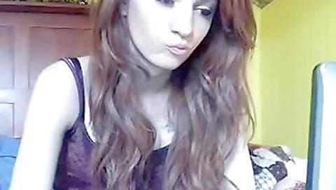 Tiny blonde woman on a hill riding a bike on a hill